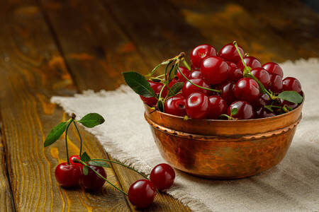 Cherries on a wooden bowl